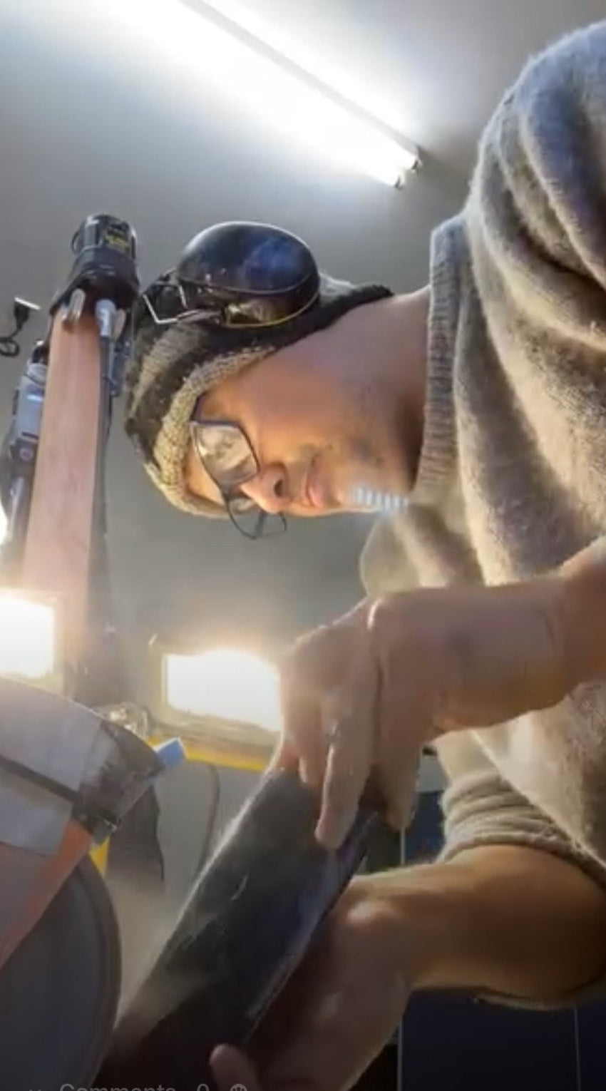Person working on a project with tools and equipment in a workshop setting